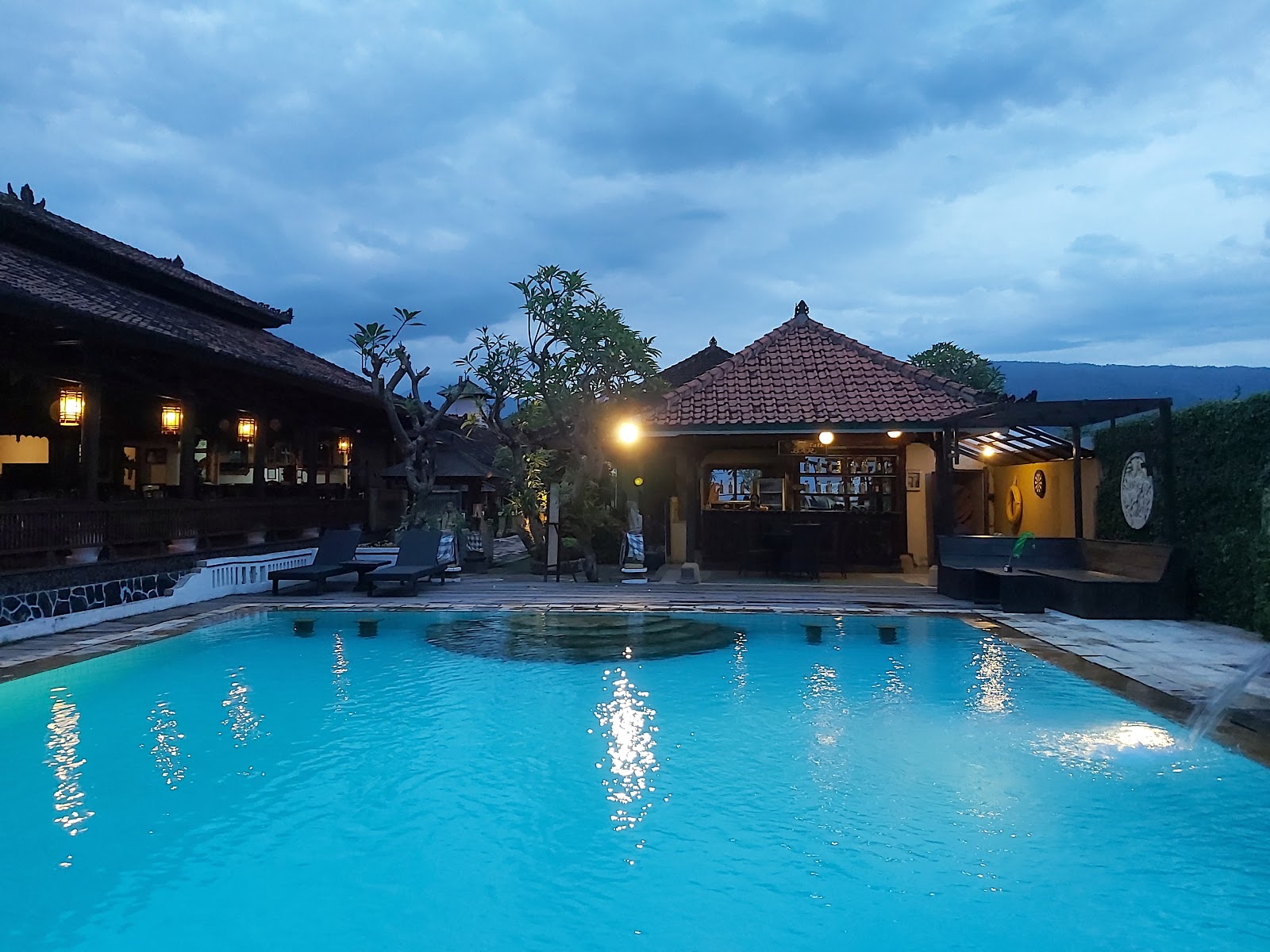 Swimming pool and traditional Balinese pavilion at Bali Taman Beach Resort