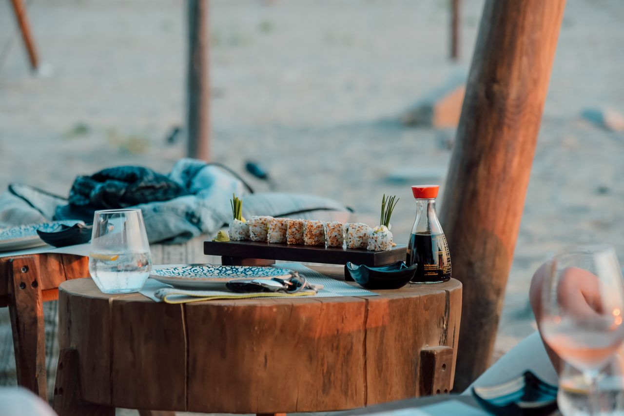 Beachside dinner table set on the sand
