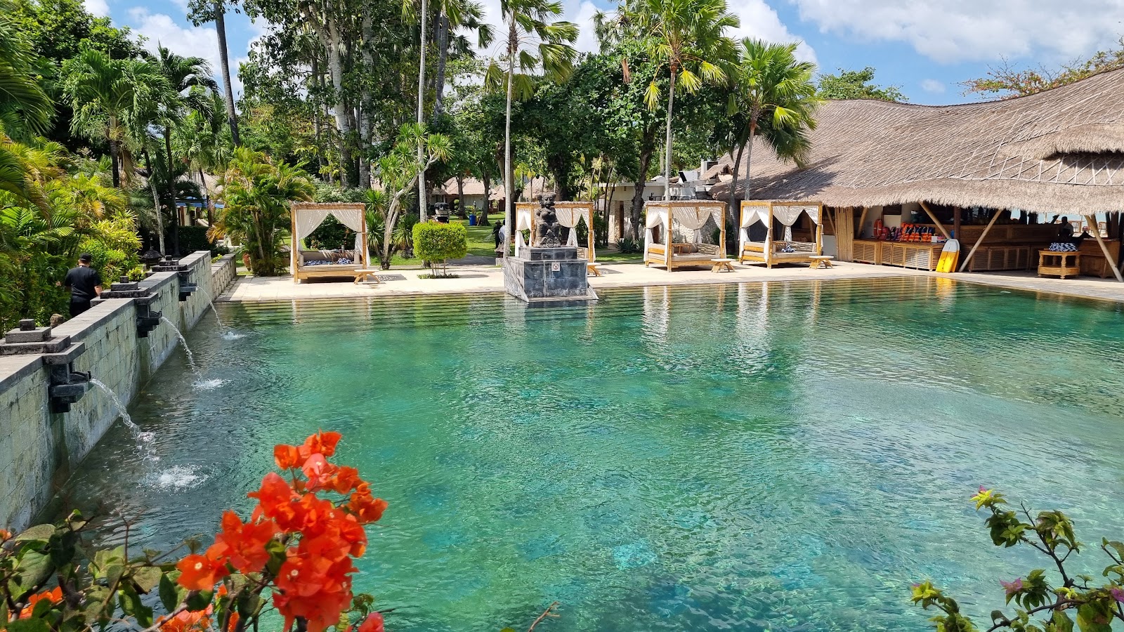 Garden pool surrounded by tropical plants at Belmond Jimbaran Puri