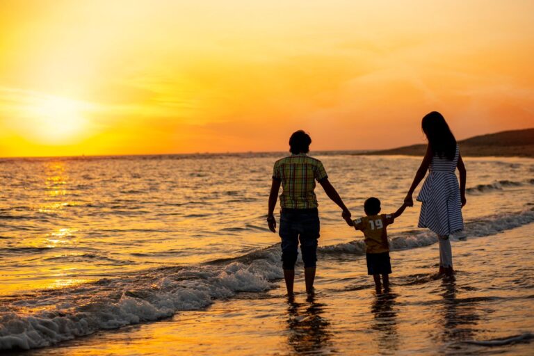 Family walking on the beach at sunset, the kind of moment the best family friendly hotels in Jimbaran offer