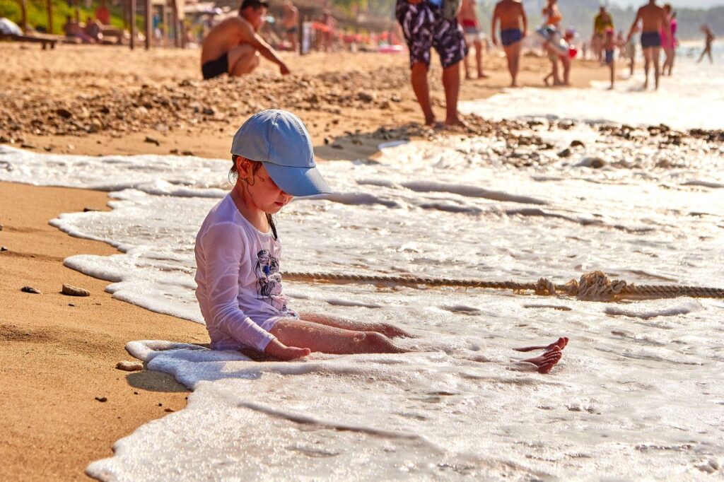 Child playing in the waves on a family holiday, inspiration for the best family friendly hotels in Nusa Dua