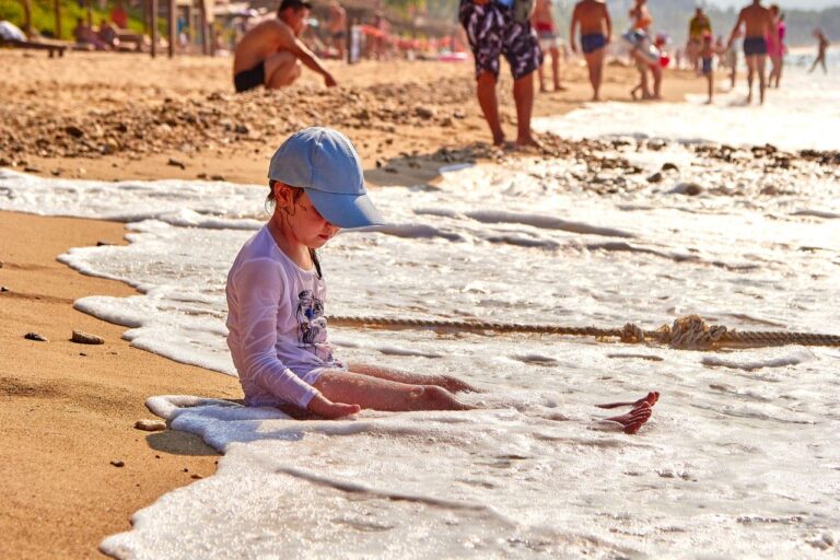 Child playing in the waves on a family holiday, inspiration for the best family friendly hotels in Nusa Dua