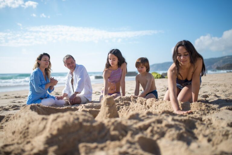 Family building a sandcastle, a highlight of staying at the best family friendly hotels in Seminyak