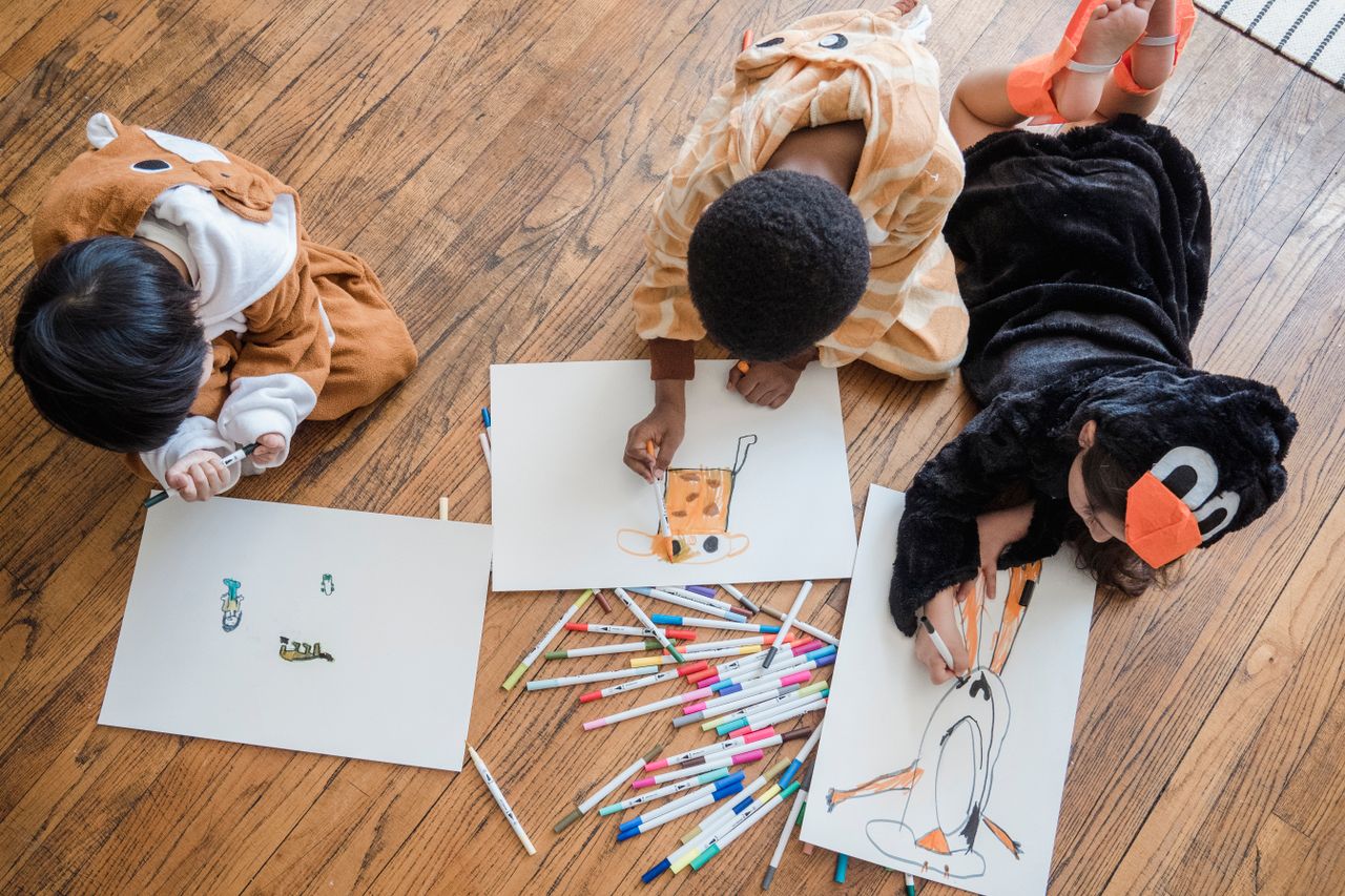 Children drawing together during a kids club activity