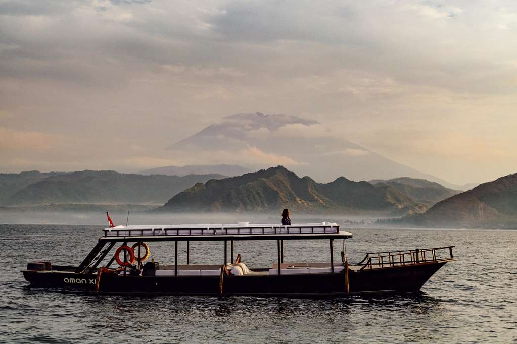 Traditional boat on the calm sea at sunset in East Bali
