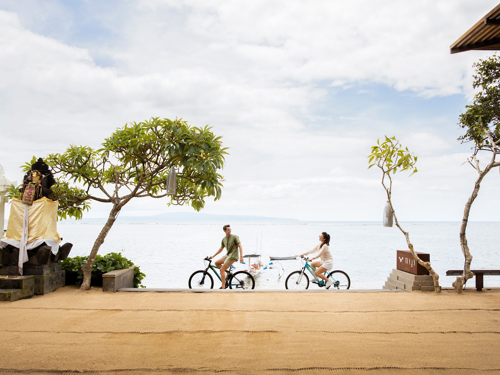 Families cycling along the Sanur beachfront path