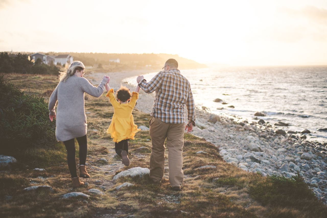 Family walking along the coast with a young child