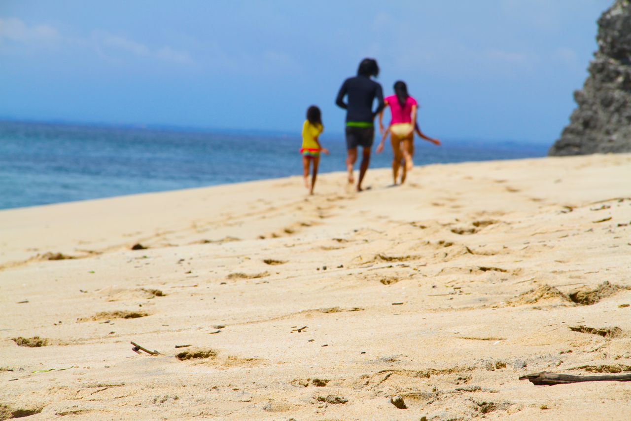 Family walking together along a sandy beach