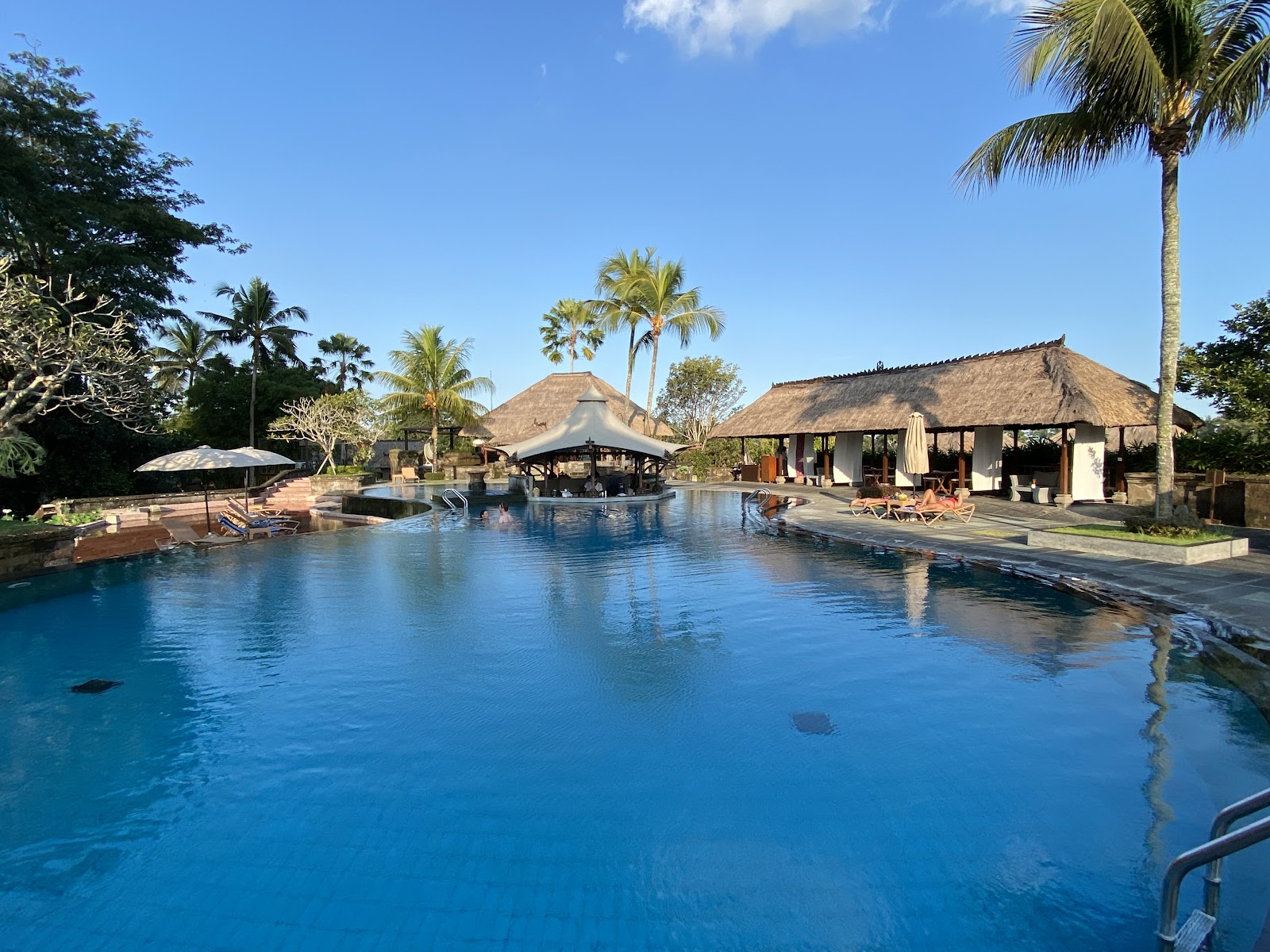 Pool framed by Balinese villas at Kamandalu Ubud
