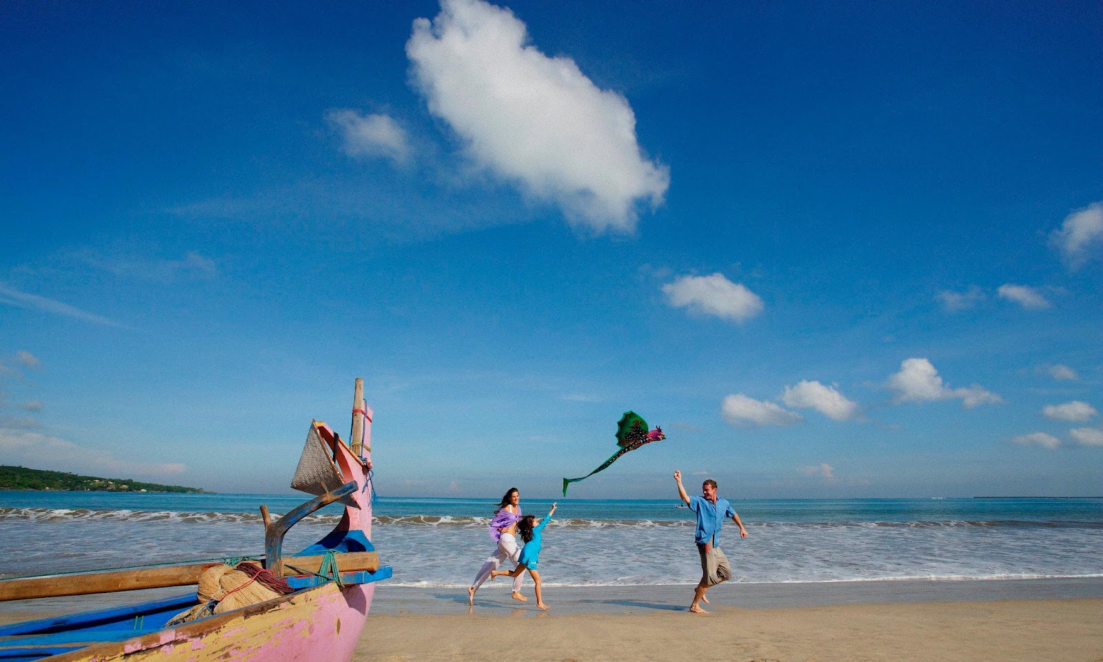 Kids playing on the calm beach at Jimbaran Bay