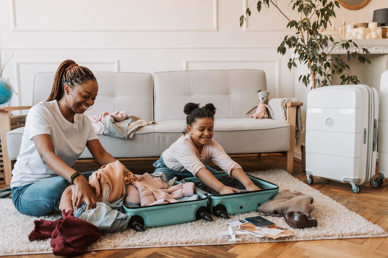 Mother and child packing a suitcase for a family holiday