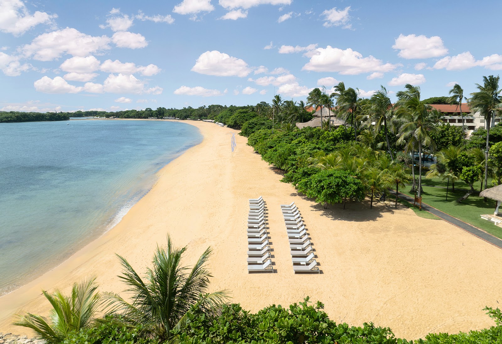 Beach loungers on the white sand of Nusa Dua, ideal for families