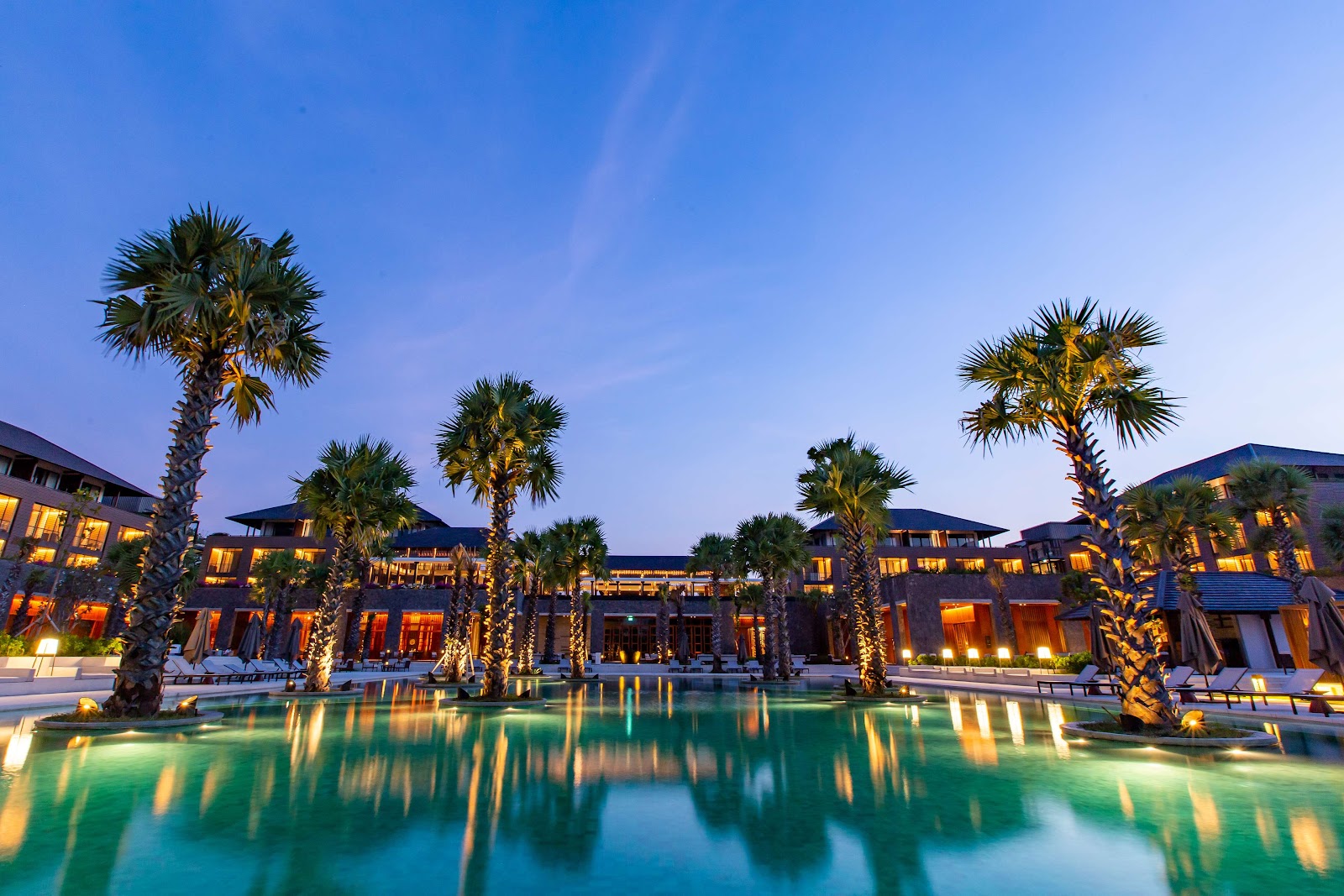 Palm-lined pool at Radisson Blu Resort and Villas Bali Uluwatu