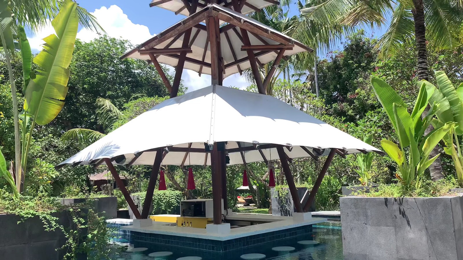 Pool with a white gazebo at Segara Village Hotel