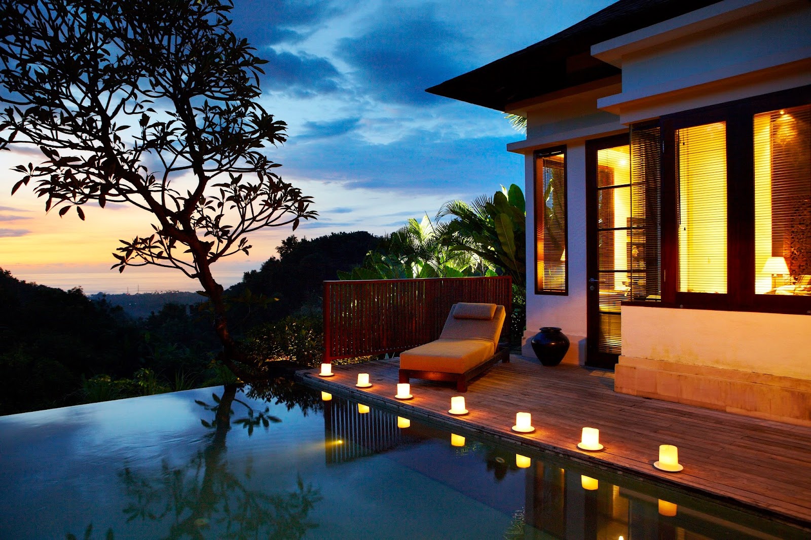 Infinity pool at dusk surrounded by hillside gardens in Lovina
